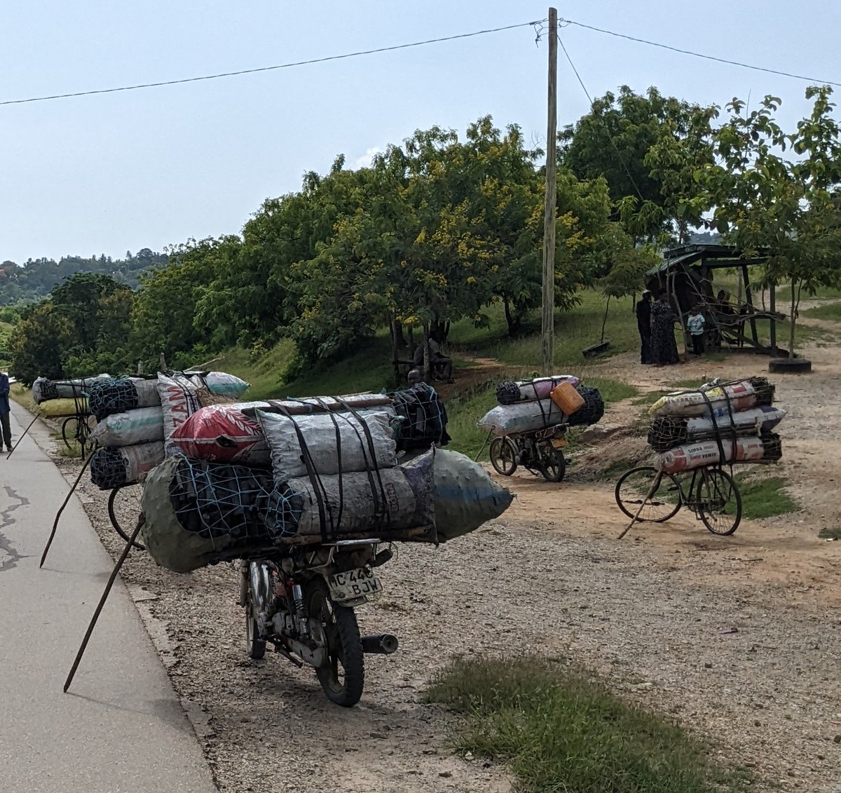 DontjeJames's tweet photo. #30DaysofBiking Bikes (and motorcycles) bringing the charcoal supply to town.  But sometimes the riders need to rest. https://t.co/ni5EyWmCLV