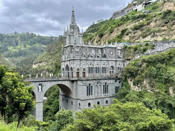 The Shrine of Our Lady of Las Lajas sits high above a deep canyon only 7 miles from the Ecuador border. The site of a miraculous appearance by the Virgin Mary, the beautiful gothic church is a Colombian national treasure. #travelblogging #colombiatravel #sanctuariolaslajas