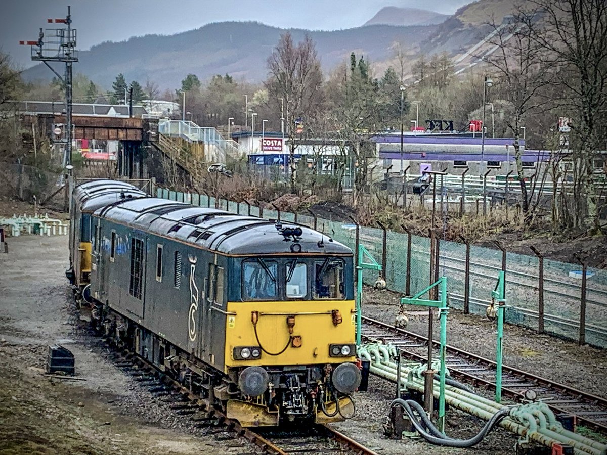 Caledonian Sleeper liveried 73962 and a classmate stand in the old oil terminal at Fort William. Ready to work that nights service as far as Edinburgh. #Class73 #Eggbox #CaledonianSleeper #FortWilliam #WHL #Trainspotting