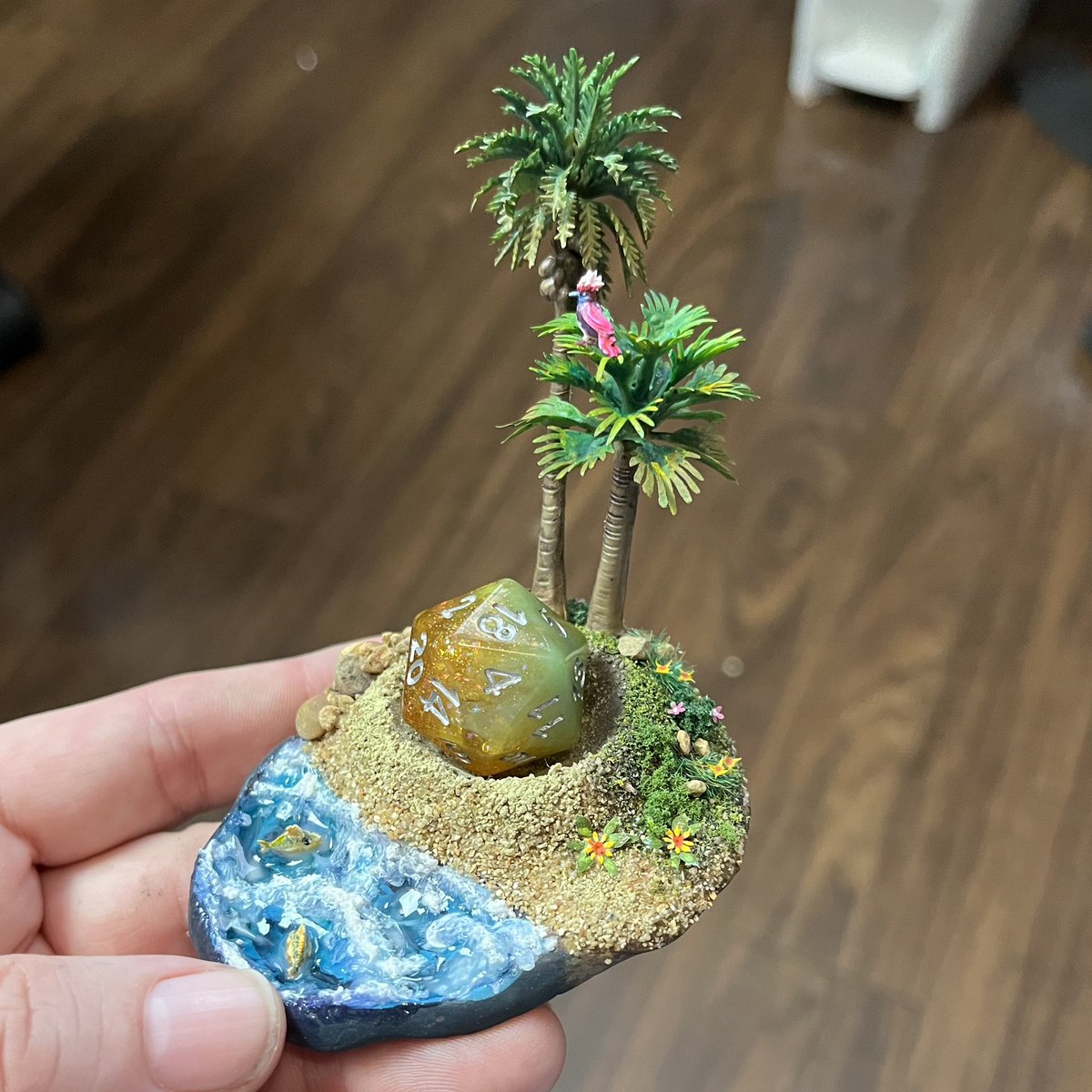 Nerfblat's tweet photo. Day off today so Iโm painting trees and making dice displays. Latest dice island is complete!So cute. Displays this Glittering Goldie die from @AdventureDice beautifully. Just have to wait for the water effects to cure. #paintingminiatures #minipainting #diceisland #dicedisplay https://t.co/AGRWh9Jytj