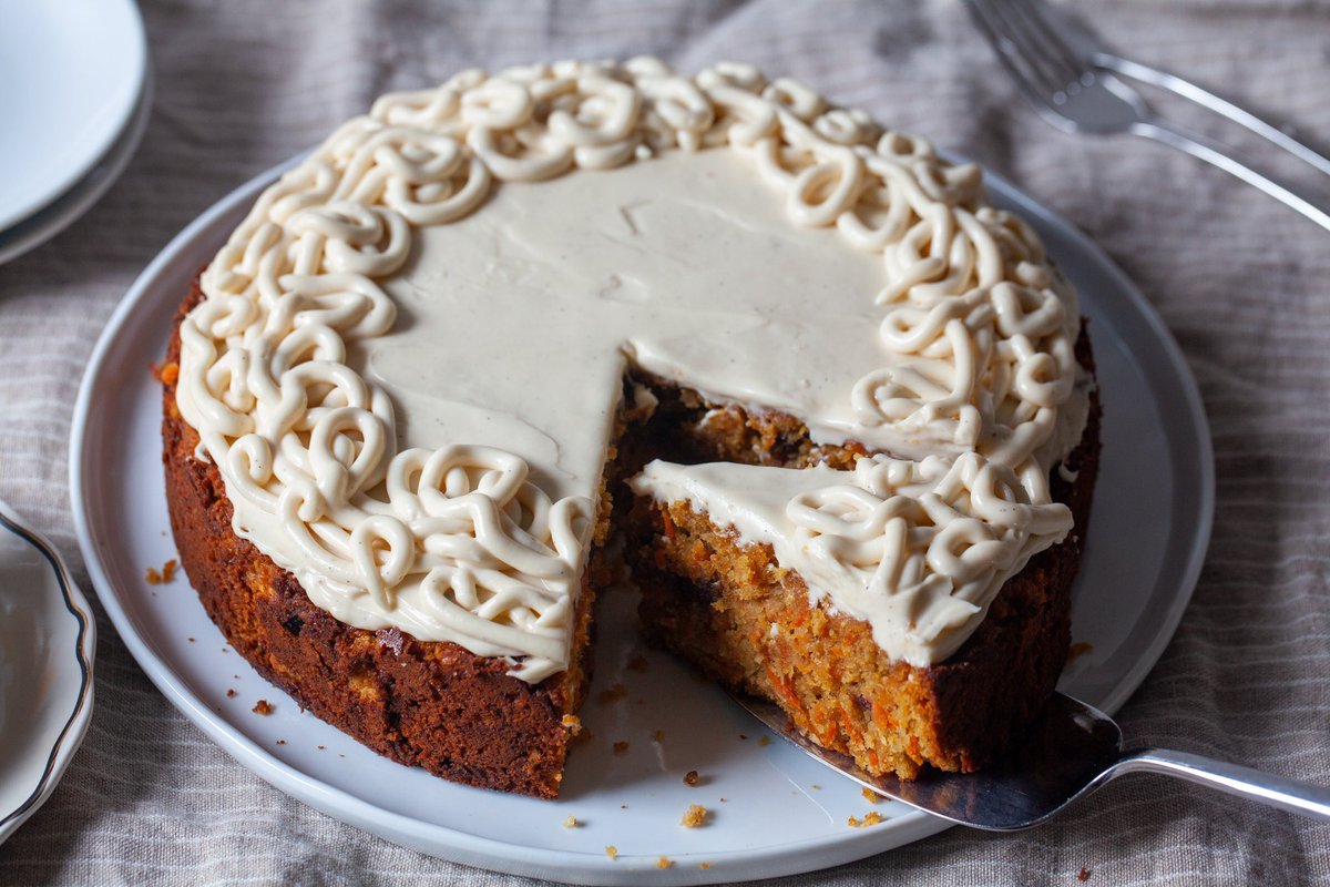 New: This flourless, dairy-optional carrot cake is hearty, spiced, and totally excused for being a little (cough) late to the April holidays because it's perfect for any day of the year, or just because the cream cheese squiggles are calling to you. bit.ly/3KrbIQt