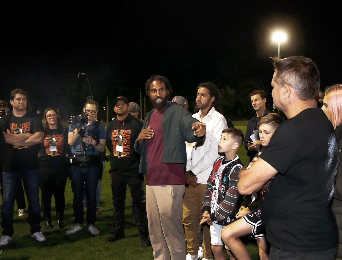 WLudbey's tweet photo. Standing in a ring of ex AFL /VFL players where Nicky Winmar lifted his jumper thirty years ago on Victoria park ex Collingwood player Heritier Lumbumba  said “ Who ever replaces Gillon McLachlan has to be held to the highest standards on racism “ https://t.co/npUvMnIJC8