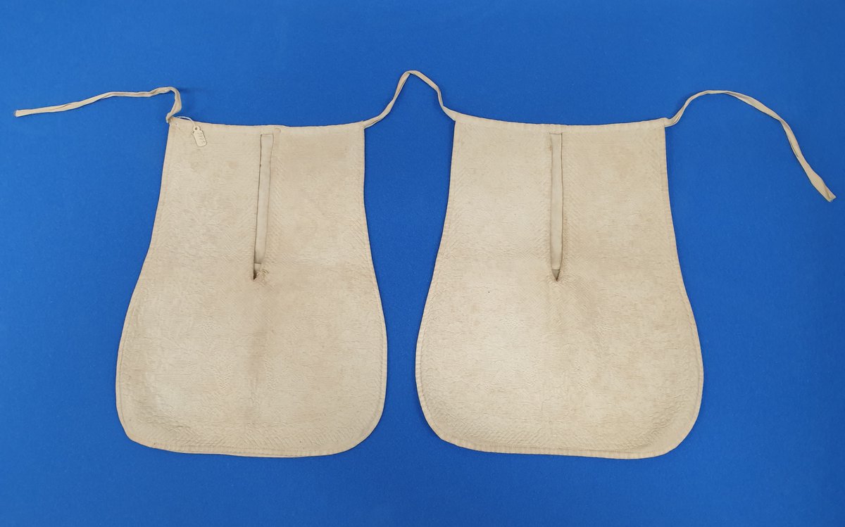 Pockets were not an integral feature of women’s clothing until relatively recently, so they wore them tied around their waist and accessed them through slits in the sides of their skirts. These date from 1850-60 and have a scalloped design, giving the appearance of fish scales.