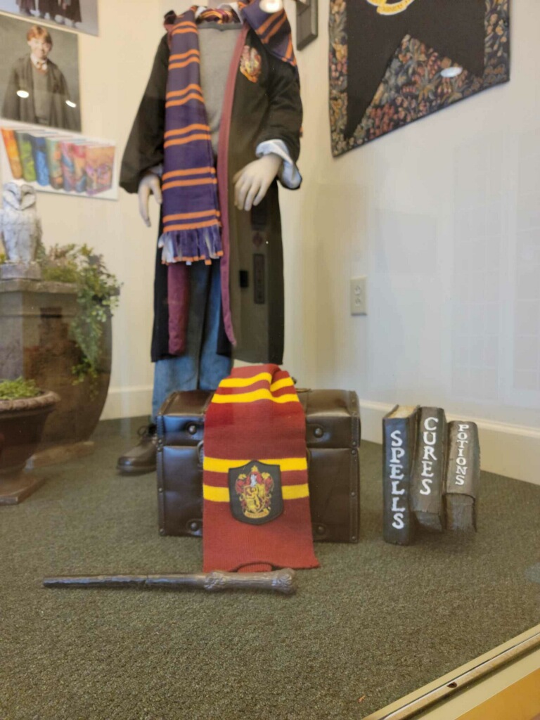 1776Bank's tweet photo. Even if you don’t know the difference between a Horcrux and a Hufflepuff, #PottedPotter will make you roar with laughter! Check out this great window display at our Jefferson Square location in #Paducah highlighting this hilarious show set for April 18th at the #CarsonCenter. https://t.co/2QEN7wzjlw