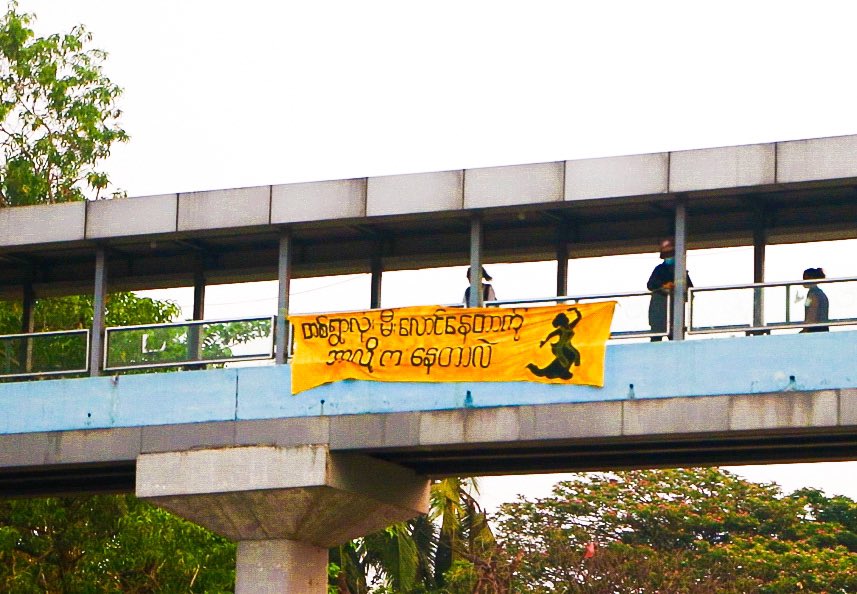 yrfmmofficial's tweet photo. This morning in Yangon, young comrades of Yangon Revolution Force - YRF Soft Strike Community hanged a banner which said “Why Are You Dancing When The Whole Village Is Burning?”. #WhatsHappeingInMyanmar #yangonrevolutionforce #YRF https://t.co/CGR40dOzDF