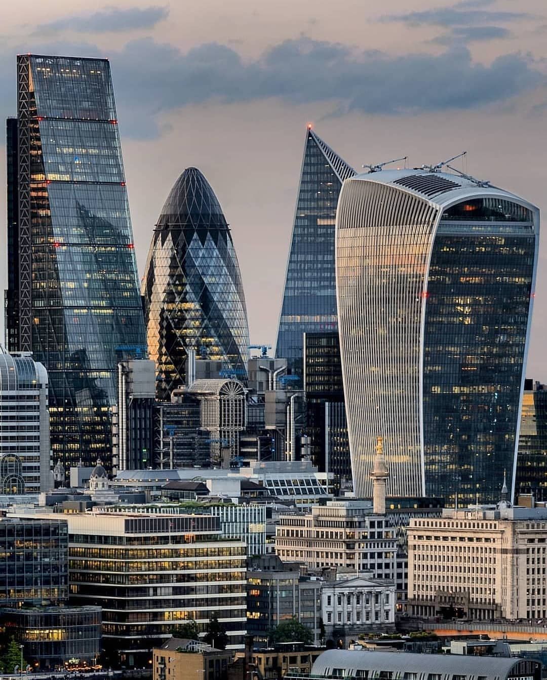 Many of its new skyscrapers are in the slightly wacky "Postmodern" style.

The Gherkin, the Walkie T