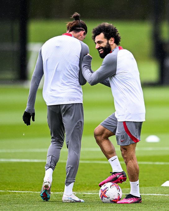 Mo Salah laughing as Darwin Nunez turns his back during today's session at the AXA Training Centre. 