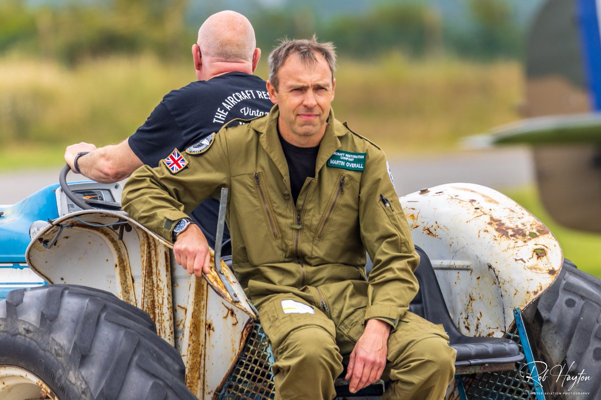 ShutterbugWGC's tweet photo. “Pilot Week”
Aerial Collective Pilot Martin ‘Mo’ Overall at the controls of the Mk. VIII Spitfire MT928 (MV154) and hitching a lift with ‘Terence the Tug’ at last year’s Duxford Battle of Britain Airshow…@ACDuxford #pilot #pilotweek #warbirdpilot #pilotphoto #pilotpics https://t.co/gDNy3HV5gy