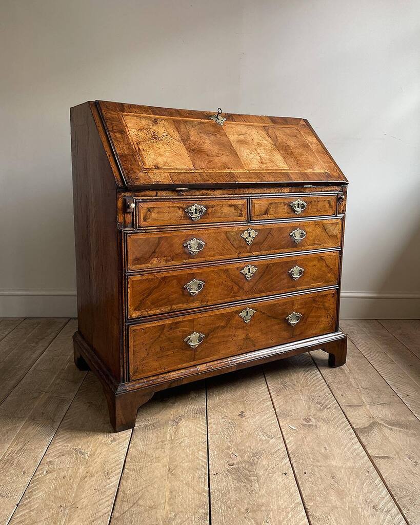 Just in: Lovely George II walnut bureau of wonderful colour and patina. Quartered figured top and fall with featherbanding and crossbanding, over two short and three long featherbanded drawers surrounded by double bead moulding, fitted with etched brass … instagr.am/p/Cq-Zzw9I-qn/