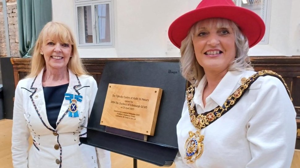 A photo of the Lord Mayor and the High Sheriff stood next to a wooden plaque