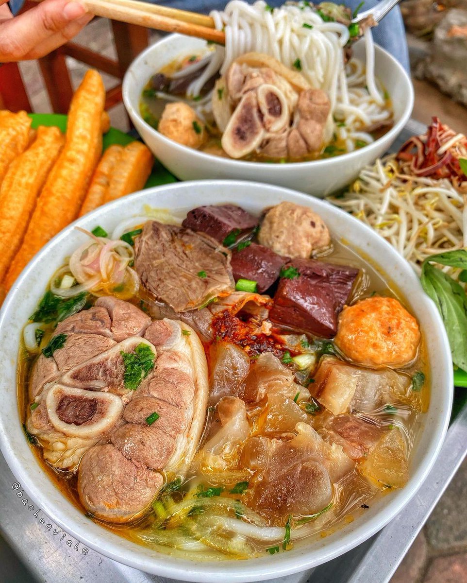 TasteAtlas's tweet photo. Hue Breakfast Noodle Soup (Bún bò Huế)
 📍 Hue, Vietnam 🇻🇳
⭐️ 4.3

Discover Vietnam: https://t.co/SfH7mAWaEG

"To my way of thinking, in the hierarchy of delicious slurpy stuff in a bowl, Bun Bo Hue is at the very top” - said the late Anthony Bourdain in the episode “Vietnam”, season four of the series ‘Parts Unknown’.

Bún bò Huế is a staple Vietnamese soup that is traditionally consumed for breakfast, consisting of pork and beef bones broth, bun noodles, lemongrass, shrimp paste, lime juice, and a variety of herbs. The soup is much spicier than most Vietnamese soups, and its flavor is often described as rich and complex.

Video: IG bachuaviahe