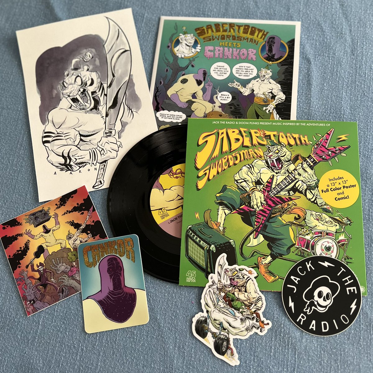 Cool swag just arrived from my pal @thegeorgehage and @JacktheRadio, featuring cool music and great art by @MatthewGAllison and an original Sabertooth Swordsman sketch by @AaronConley77! #jacktheradio #cankor #sabertoothswordsman #comics #music