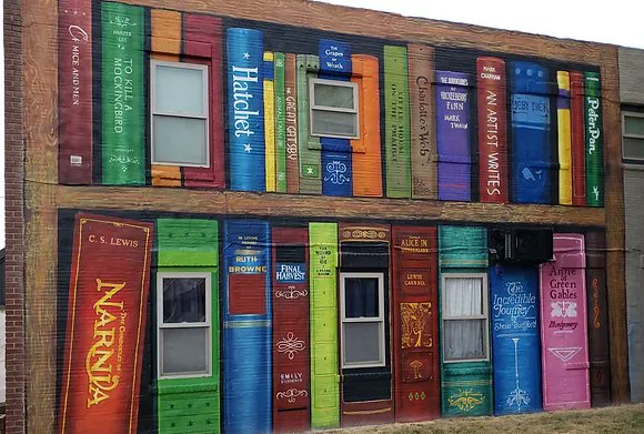 DebOhlde's tweet photo. Many things can brighten your day. Today it was rain for a very dry Kansas. Earlier this week it was time in the sun in Clay Center enjoying the bright colors of their murals - books are my favorite - check out their county-wide mural movement - https://t.co/fmebFbrQvq https://t.co/XyHBrUFN5Y