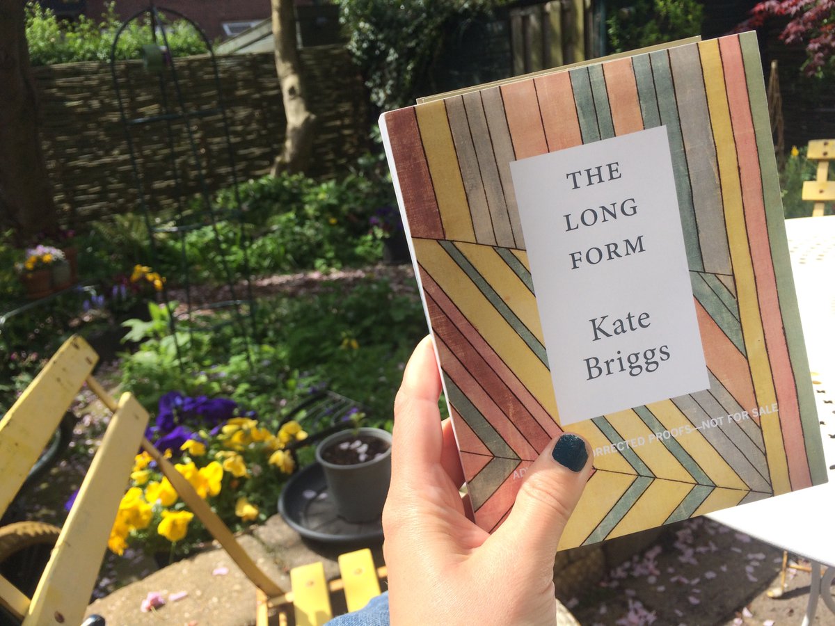 It's Kate Briggs's very own hand holding Kate Briggs's copy of THE LONG FORM galley in Kate Briggs's pretty garden in Rotterdam! 💛