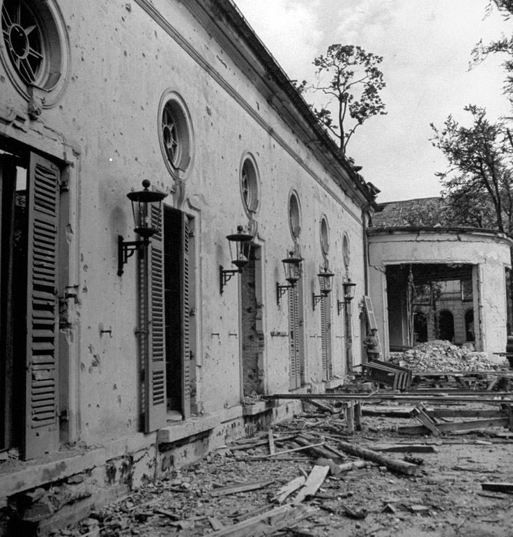 Adolf &amp; Eva's corpses are carried to garden of the Reich Chancellery, wrapped in a blanket. Soaked in gasoline, they're set alight with burning rags.
