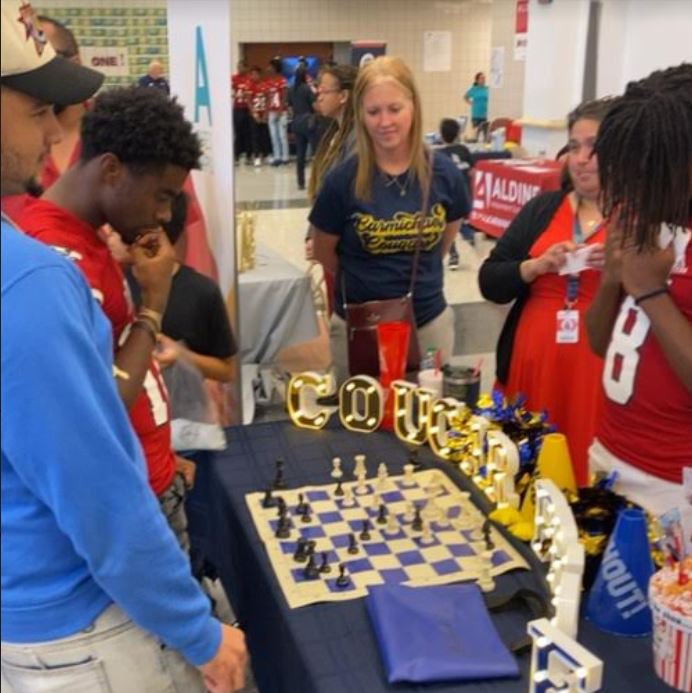 Carmichael_AISD's tweet photo. Pictures from our time at the Davis HS Vertical Community Meeting! After our  Cougars said the welcome and pledges, our students watched a few Davis HS football players play chess! https://t.co/zCVnDkso5g