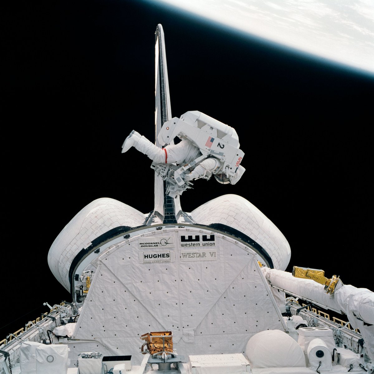 Pick your favorite EVA outfit:
Left: Astronaut Bruce McCandless testing the Mobile Foot Restraint at the end of the RMS arm
Right: Astronaut Bruce McCandless testing the Manned Maneuvering Unit (MMU), on the first ever untethered spacewalk