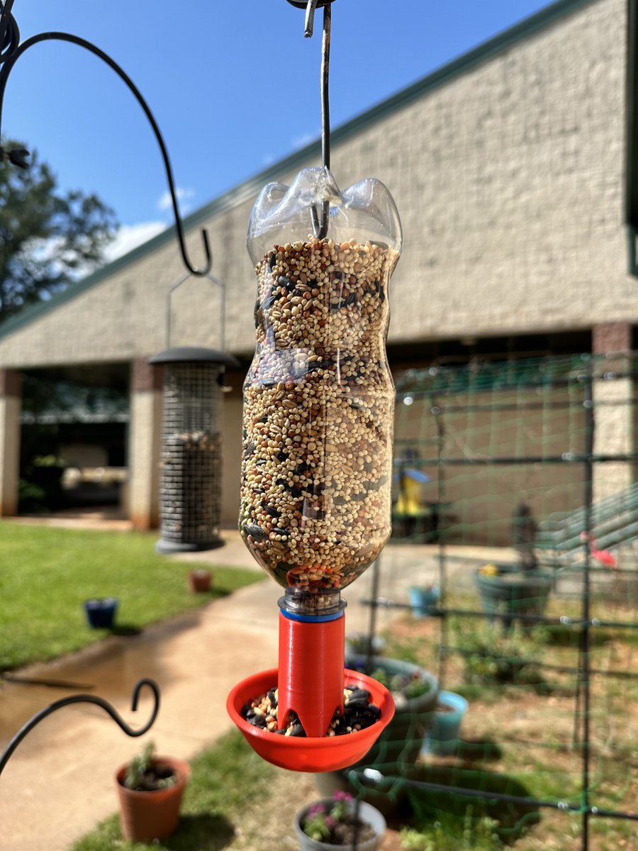 WestLakeElem's tweet photo. 20oz soda bottle liberated from a trash can + 3D printed 'cap' + a bit of scrap wire = fully functional bird feeder. The perfect addition to the WLES Pollinator Pathway and part of our (Re)Create initiative. @STEM_WCPSS @WCPSSTeam #wlestem #EarthDay https://t.co/PxwROmKaWi