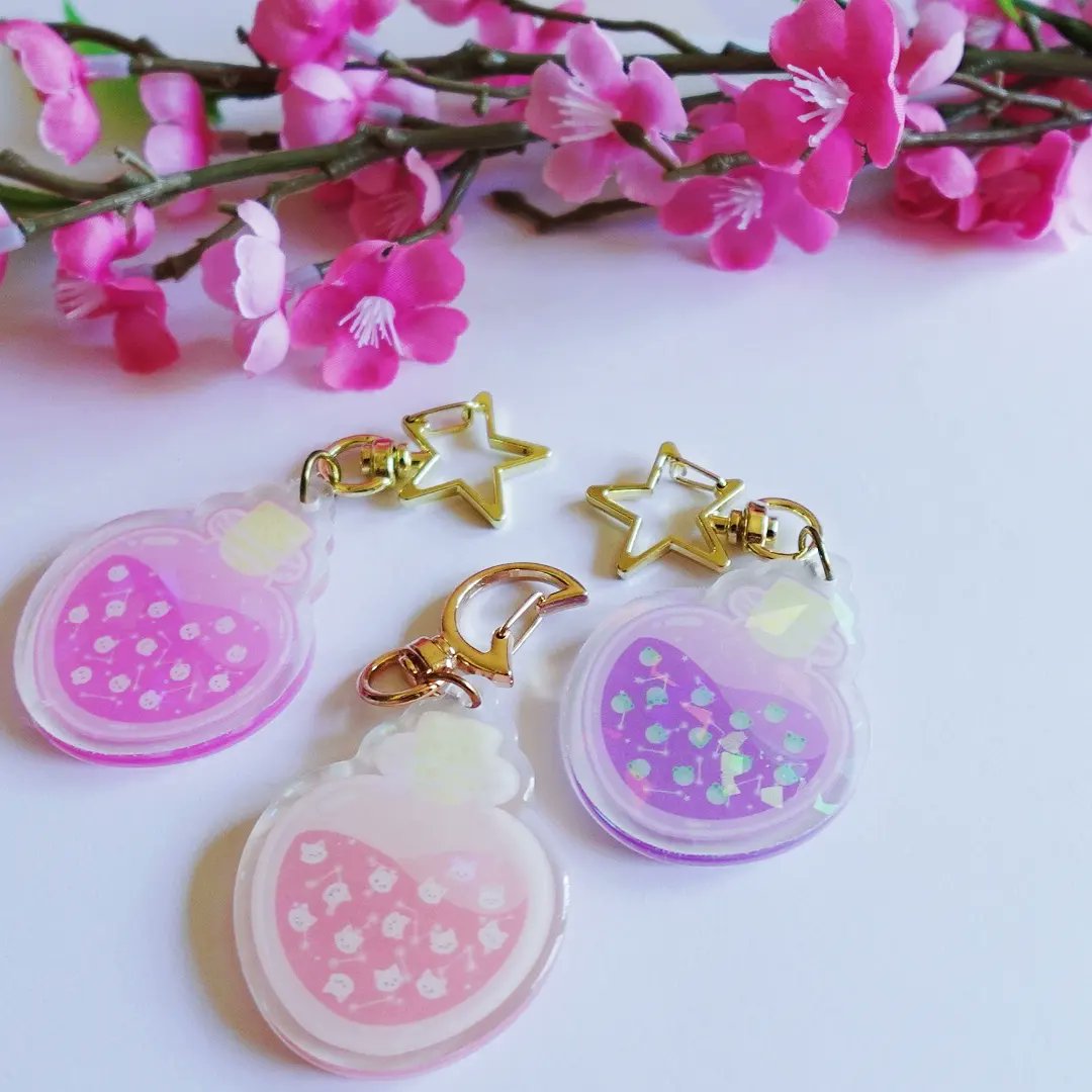 Pick your potion 🔮✨️🐰🐸🐱 holographic keychains are now available and come with matching mini sticker set! #art #cuteart #keychains #kawaiiaesthetic #potion #artistsontwitter