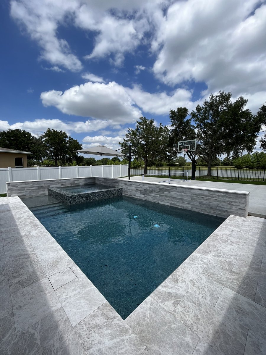 A hidden skimmer cover helps your deck look seamless. Can you find it? #Pool #poolbuilder #pooldesign #custompools #wintergardenpools #orlandopools #wintergarden