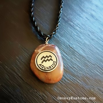 Custom braided leather necklace with polished rock and zodiac sign going to someone very special 🩷 Need a one of a kind piece for yourself or a loved one? DM me and let's design it or for ready to purchase pieces visit SmokeyKustoms.com 🩷