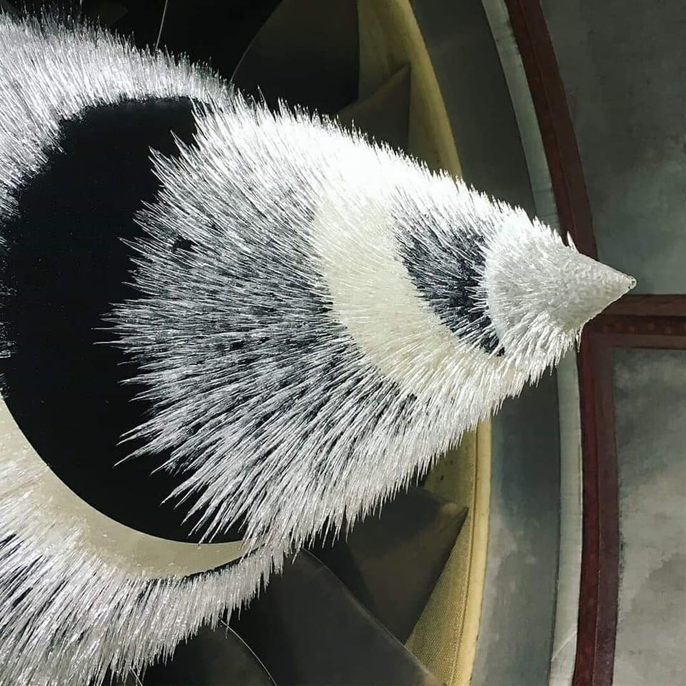 Ice forms readily as aircraft ascend to cruising altitude. Heavy rain or snow makes this worse. If it builds up in quantity, large chunks can break off and enter the engine core, causing damage.

But encourage it to break off early, in smaller chunks, and it's harmless.