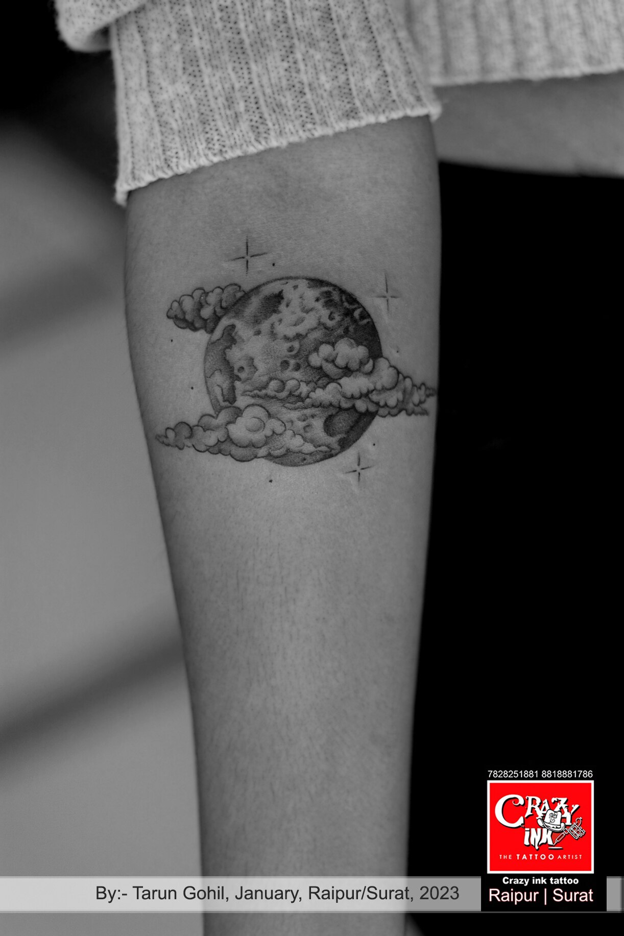 Cloud tattoo on the inner forearm.