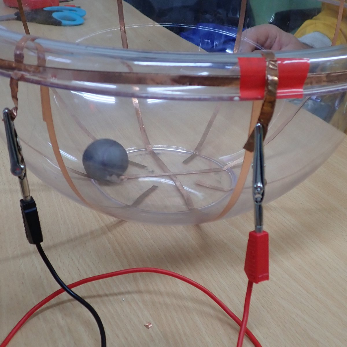 PhilipMRussell1's tweet photo. 🌀 Trying out a cyclotron! Made from a mixing bowl, copper tape &amp; powered by a Van de Graaff generator⚡. The Ping-pong ball circled the bowl, but not too fast 🏓💨 #DIYcyclotron #sciencefun https://t.co/idoKBNlHW3