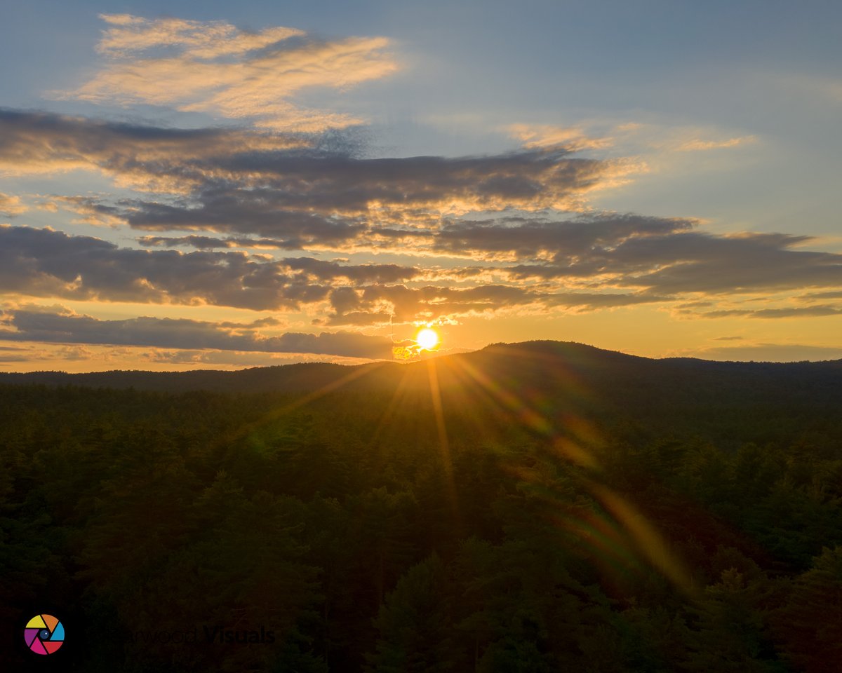 ClearwoodVisual's tweet photo. Check out this stunning sunset shot over the mountains from East Baldwin, Maine. Captured from a drone flying over Sand Pond! The mix of warm and cool colors in the sky creates a breathtaking scene. 😍 #Maine #sunsetphotography #dronestagram https://t.co/7AvNKq6A8Z