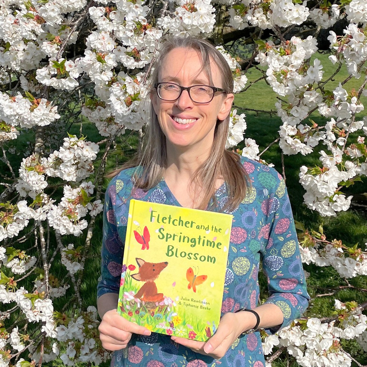RawlinsonJulia's tweet photo. I’ve been waiting for 🌸peak blossom🌸to take Fletcher and the Springtime Blossom to #AbbeyFields. Later than last year but we finally made it. Bright sun and wind - enjoy the squinty windswept author photo! #FletchersFourSeasons #FletcherAndTheSpringtimeBlossom #BlossomWatch https://t.co/NFmf7xNVB2