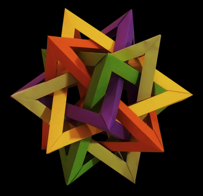 Five tetrahedra, each in a different color and each made with 30 sheets of paper with no scissors or glue, intersect to form this Origami creation. Find the instructions for this and many more Origami models at mathigon.org/origami.