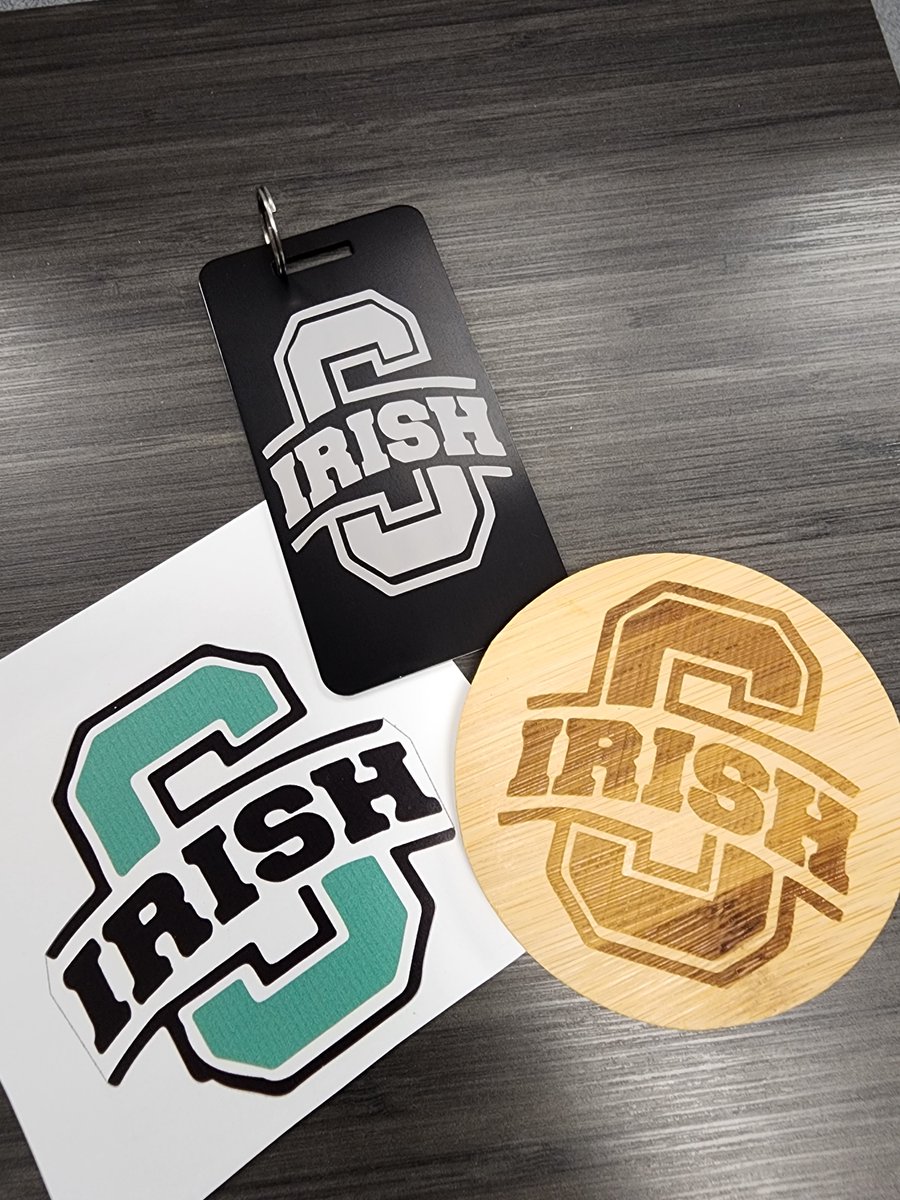 sciotolibrary's tweet photo. Getting ready to put gift packages together for winners of our literacy trivia for National Library Week next week! Sticker, luggage tag, and coaster all made and designed in the Scioto library makerspace! Products available for sale as well! #irishnation #maker https://t.co/4akGmq7jqN