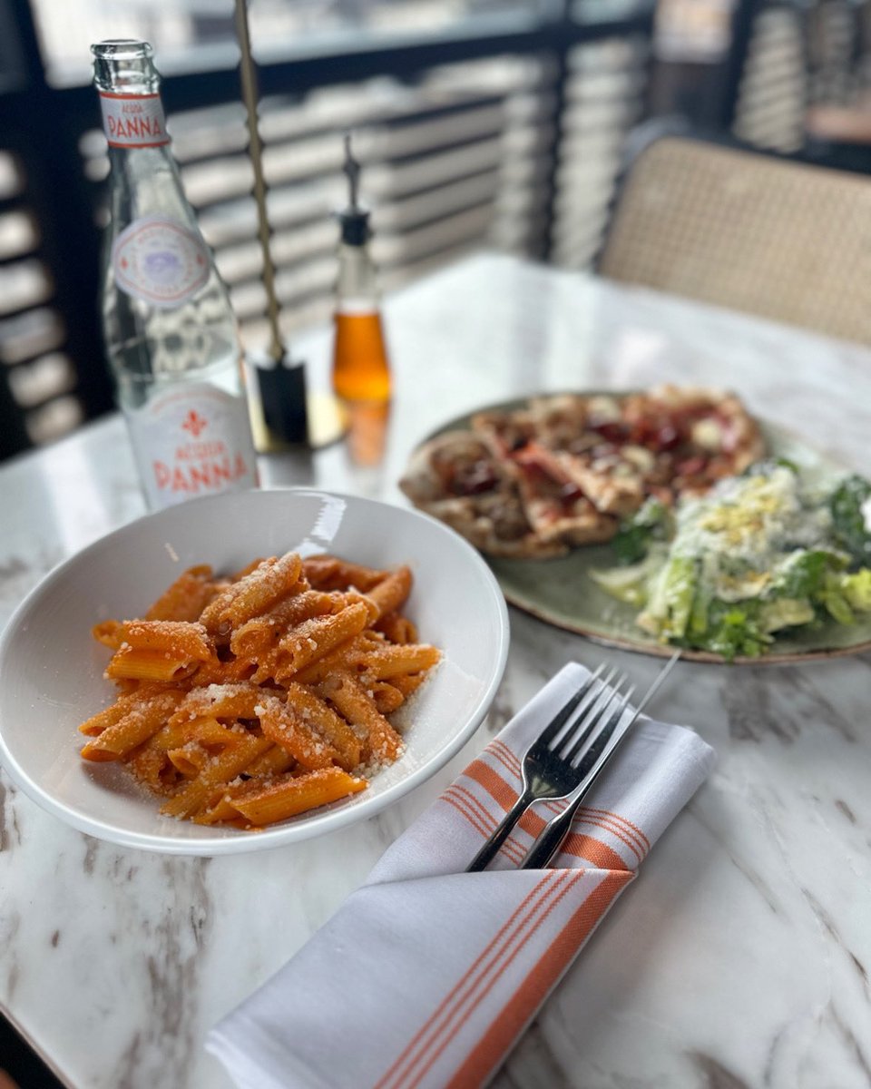 Lunch is served! Join us everyday for Half-Price wine during lunch! Pictured is our gluten free pasta with vodka sauce and our $15 flatbread &amp; greens lunch special.