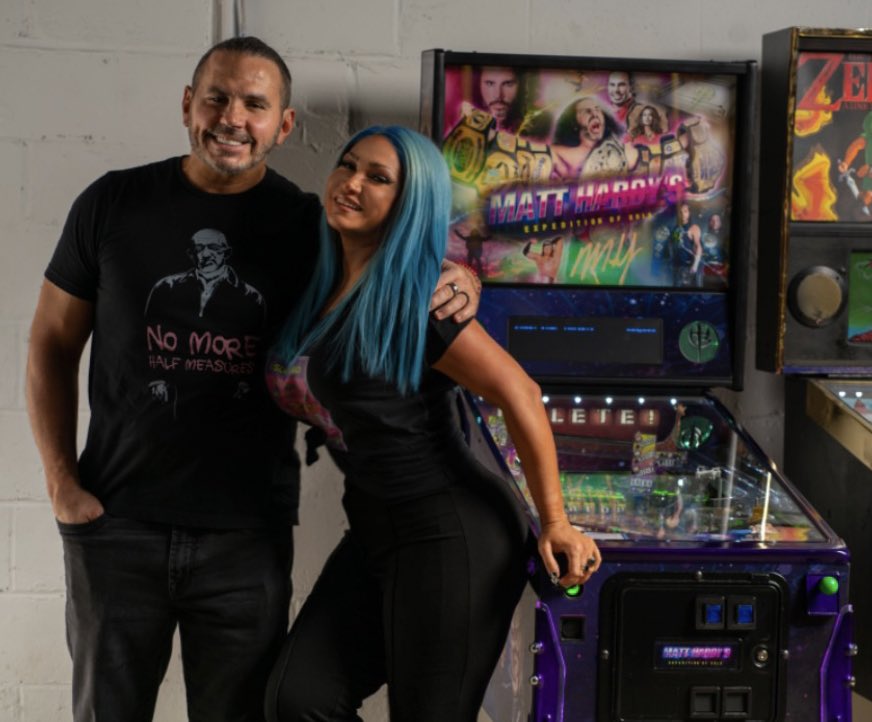 MATTHARDYBRAND's tweet photo. Love this pic of me & my beautiful wife, @RebyHardy, as Matt Hardy’s #ExpeditionOfGold (a pinball machine she created based on my entire career) is on display at a prestigious pinball show.❤️ https://t.co/pUulErsWdn