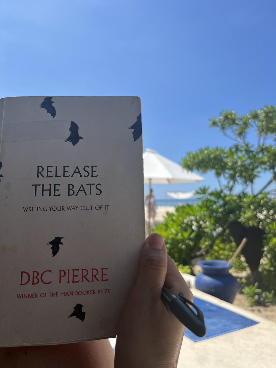 ElfordElizabeth's tweet photo. Always a good idea to bring the dog-eared and coffee stained Release the Bats by DBC Pierre on holiday in case your writing (and confidence) needs amping up. #releasethebats #amwriting #gilimeno #Lombok #writingpoolside https://t.co/DzWfsi7IhM
