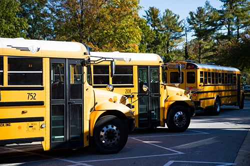 Buses parked in front a school.