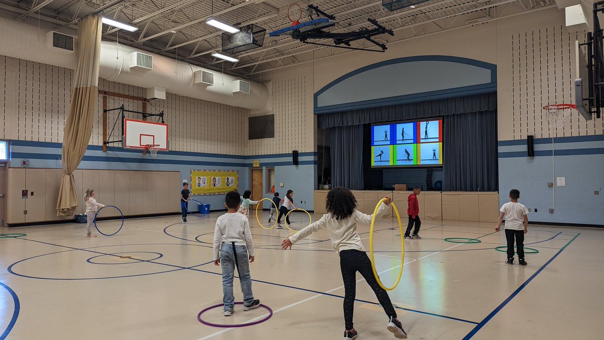 Students from Ms. Trumbauer's 2nd grade class loved this great warm up activity from <a href="/kellidsmith/">PEwithCoachSmith</a>. Students practiced locomotor movements around the gym and then performed different challenges with a hula hoop. #PhysEd #fvfoxes