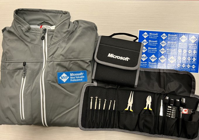 A pic of a jacket, toolkit and stickers.