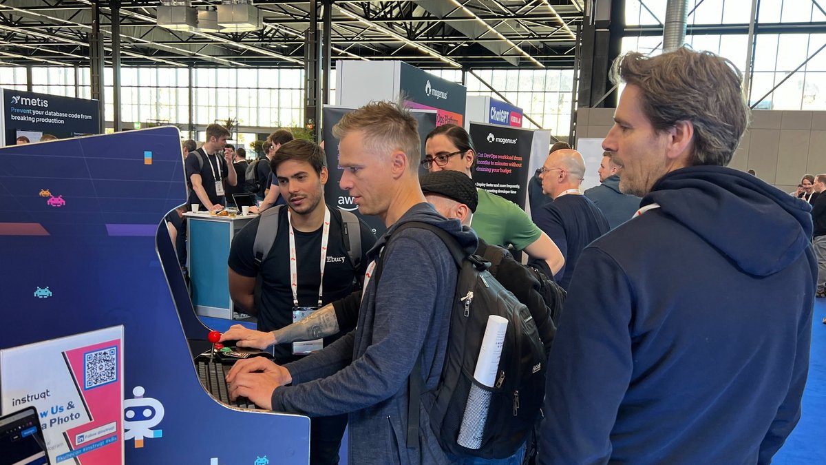 instruqt's tweet photo. "We're having a blast at #kubecon23 and #cloudnativecon! Come say hi at booth SU10 and check out our innovative product demo and training platform. Plus, play our retro-inspired Instruqt arcade - it's a total hit! 🕹️👾" https://t.co/7Y88Dy4FXA