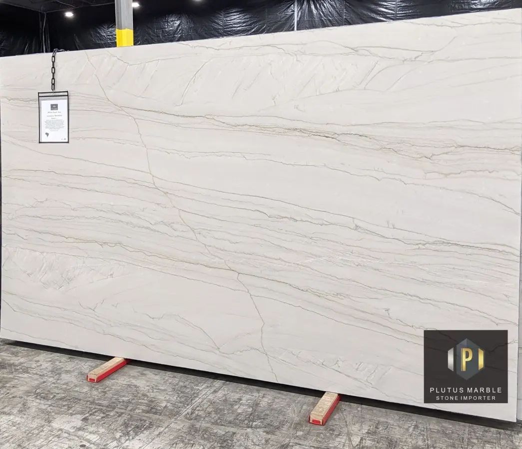 PlutusMarble's tweet photo. White Pearl Quartzite is back and we know you'll love it! Beautiful neutral tones, subtle veining, this piece has it all. #QuartziteCountertops #UseNaturalStone #PlutusMarbleIndy #MeetMeAtPlutus https://t.co/EvjmskFdBh