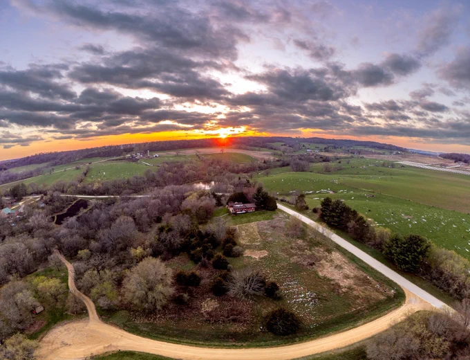 Drone sunset looking west with Glennalough centered in the distance