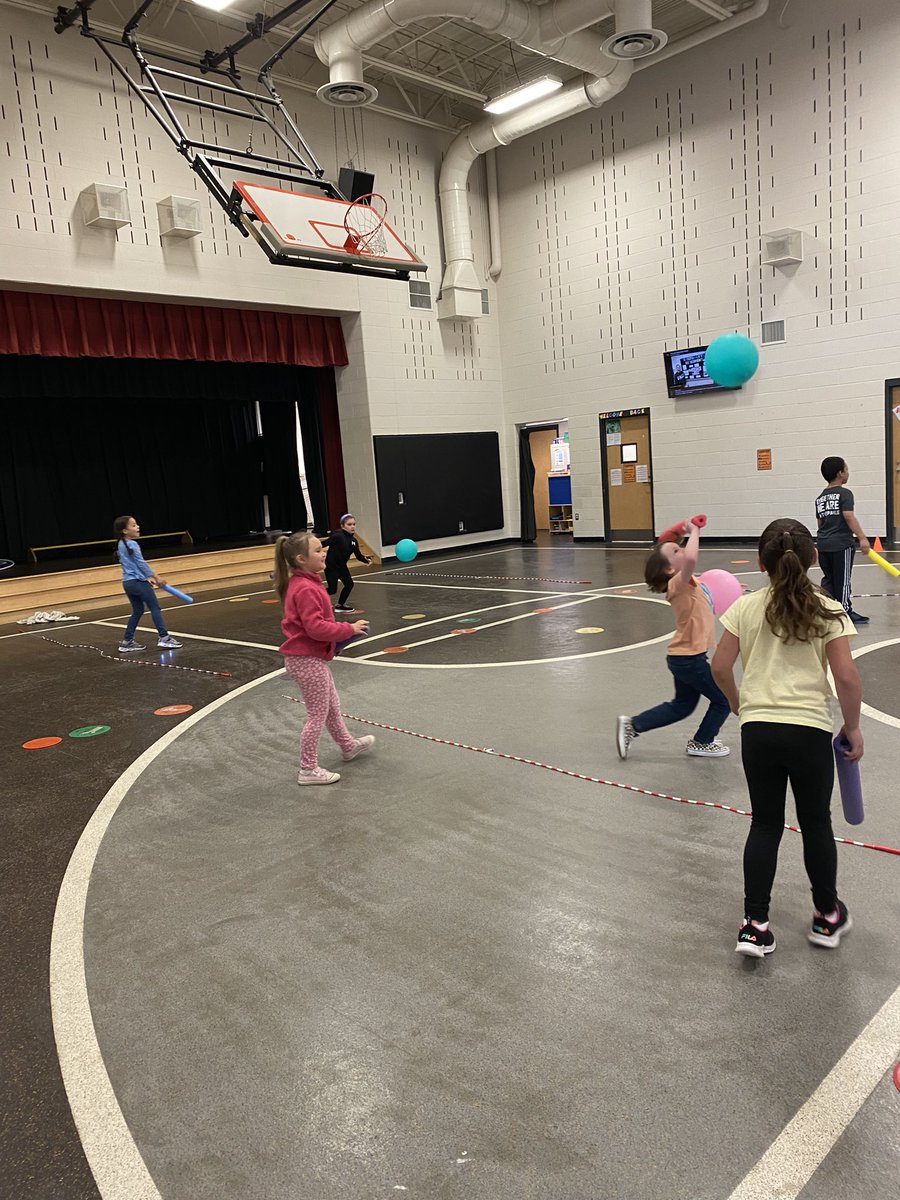 1st grade enjoying balloon tennis.