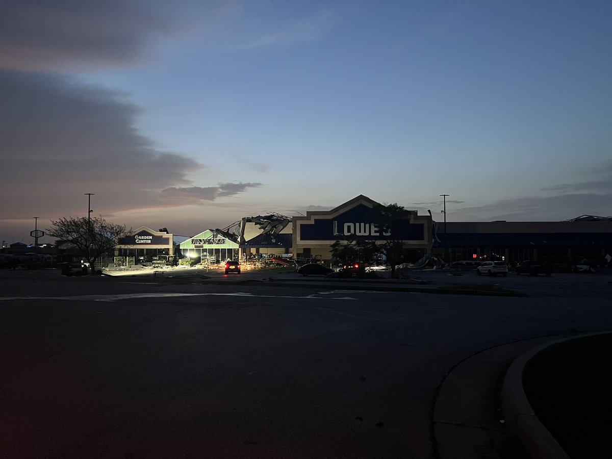 _anslee's tweet photo. As the sun comes up we are seeing more of the damage in Shawnee. The tornado ripped through a major shopping center area with several food places receiving damage. Look at the storage unit moved from Bricktown Brewery. Lights poles laying on the ground. Building roofs torn off. https://t.co/xrMFCaCtsu