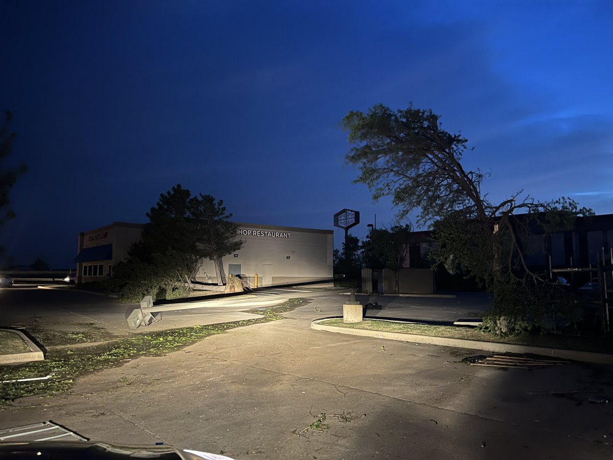 _anslee's tweet photo. As the sun comes up we are seeing more of the damage in Shawnee. The tornado ripped through a major shopping center area with several food places receiving damage. Look at the storage unit moved from Bricktown Brewery. Lights poles laying on the ground. Building roofs torn off. https://t.co/xrMFCaCtsu