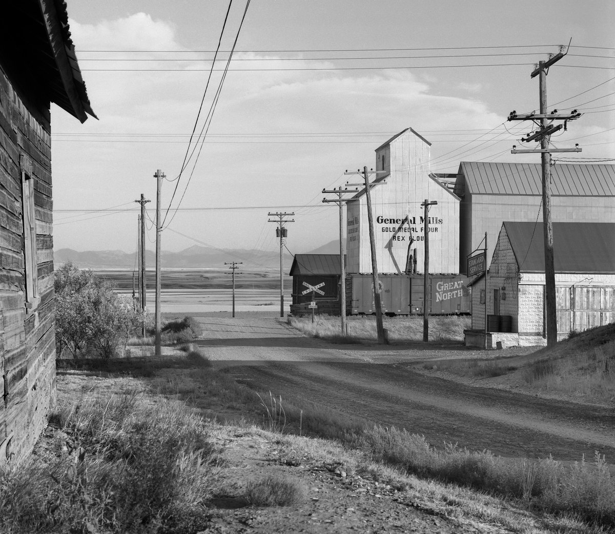 GrohmannMuseum's tweet photo. “The Architecture of Agriculture” opens tomorrow! The Grohmann Museum once again showcases the #photography of #Americanartist David Plowden! The exhibition looks at feed mills, grain elevators, and barns: the human impact on the landscape of America. https://t.co/bjDFOrDmZL