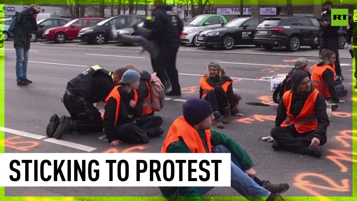 RT on Twitter "Climate protesters glue themselves to Berlin road"