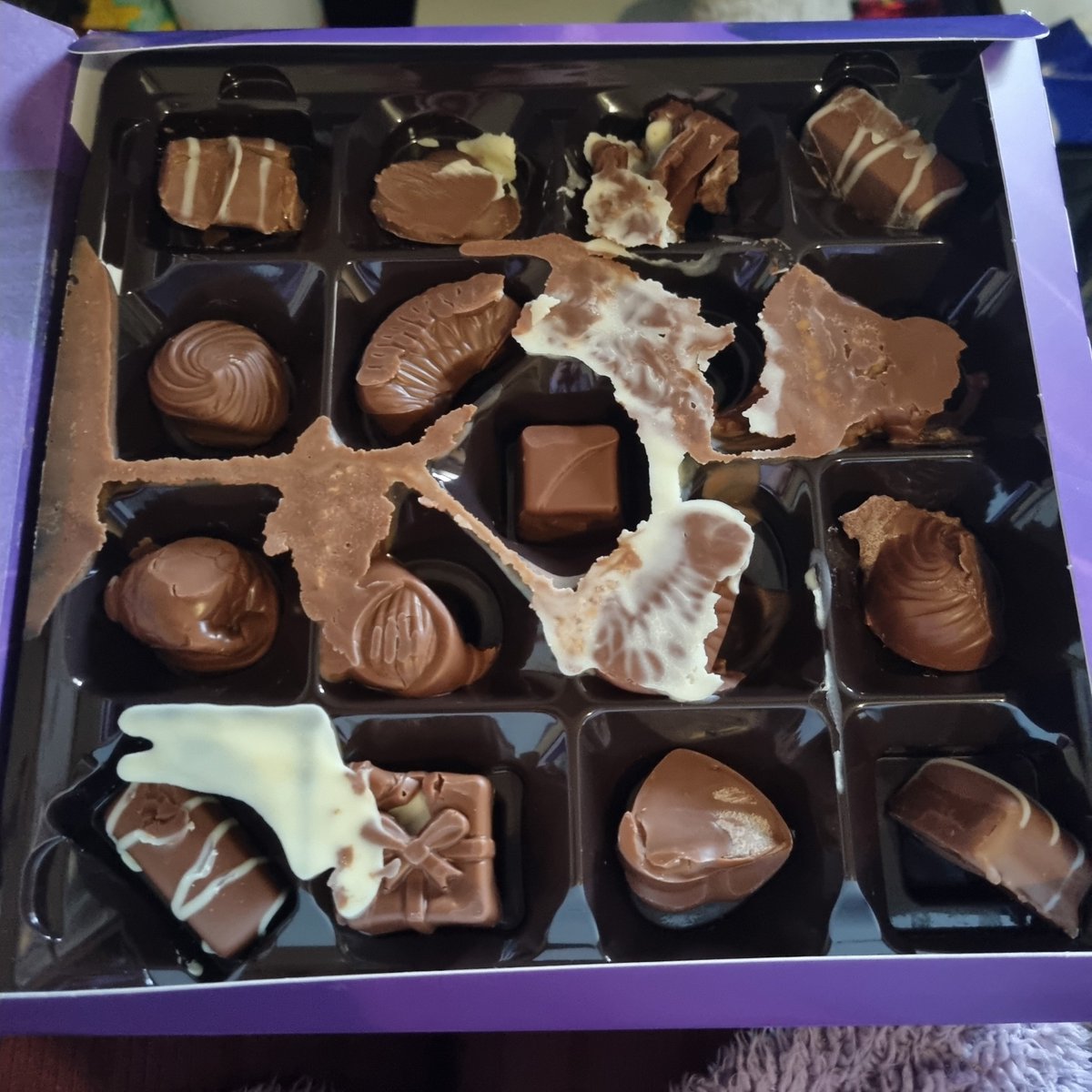 beccafee's tweet photo. @CadburyUK 
Was gifted some milk tray yesterday from a lovely student nurse. Opened them today to find these squished melted messes 🥺
#devastating 
#howdiditpassQC
#pregnantandchocolatestarved https://t.co/cYBqrUJaQ9