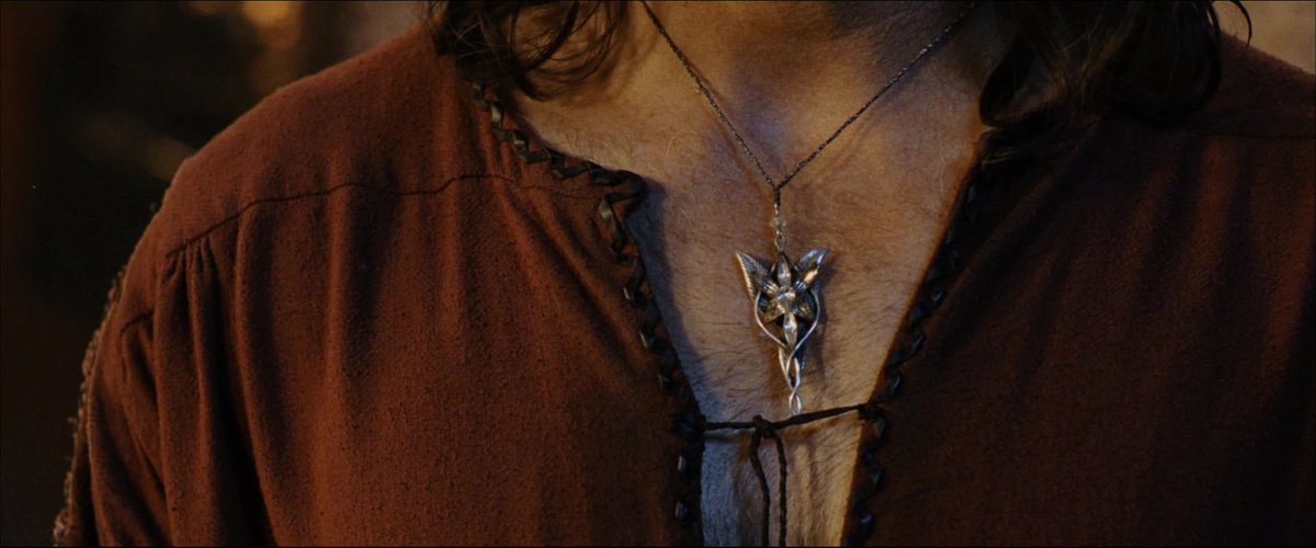 This shot is obscene.... a delicate jewel which symbolically represents his gf's forsaken immortality nestled in his big hairy breasts boobs tiddies and jugs as he tiptoes around in nothing but his open nightgown... ok
