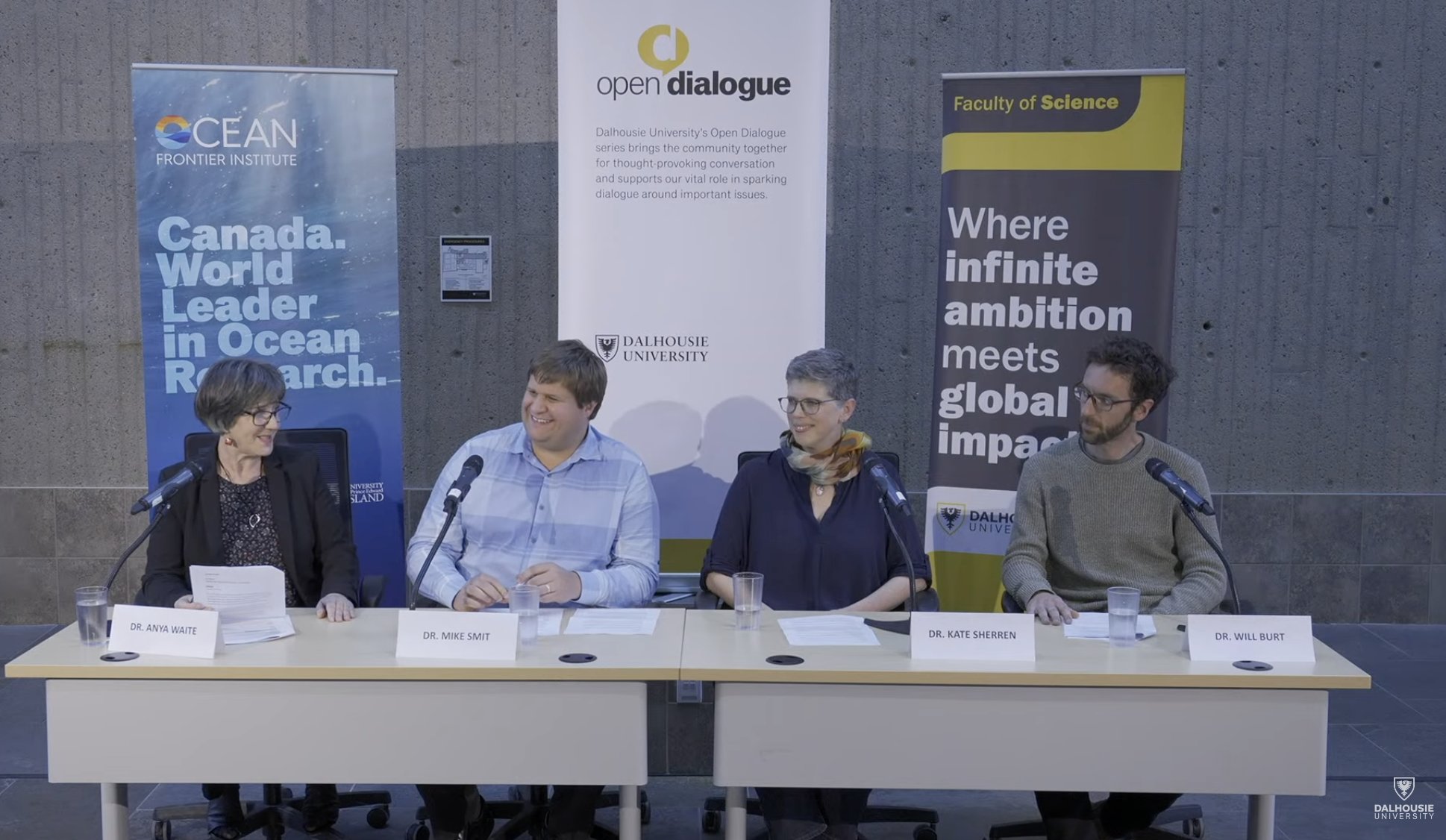 Four scholars in a panel set up in front of Dalhousie banners.