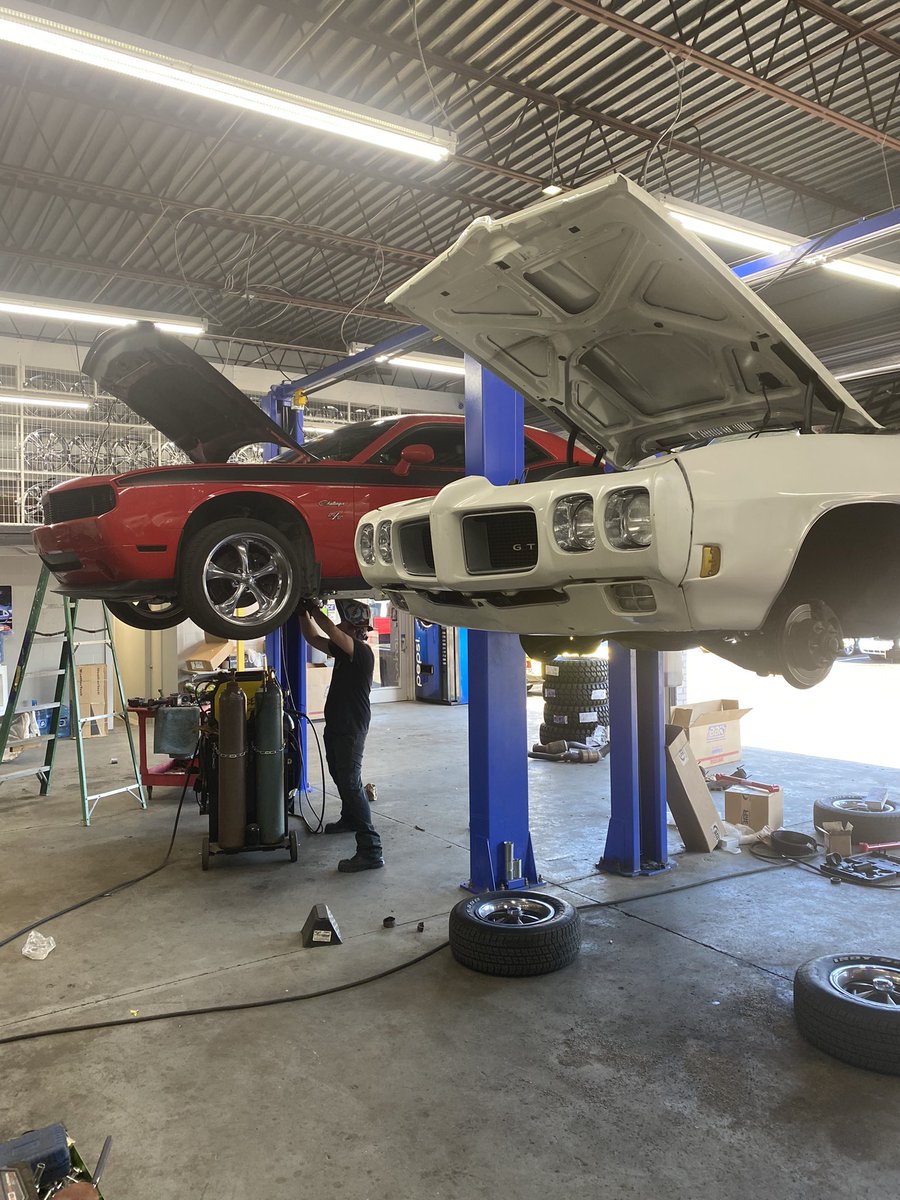 TheshopFL's tweet image. How do you like your muscle? Here we have a modern Procharged Dodge Challenger getting some long tube headers installed side by side with an iconic Pontiac GTO that’s getting a full pro touring suspension upgrade. Great cars made even better at The Shop! #moparnation